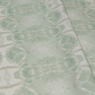Luxury abstract botanical fabric featuring layered tree-inspired movement in calming jade green and soft neutral tones for collected modern traditional interiors.